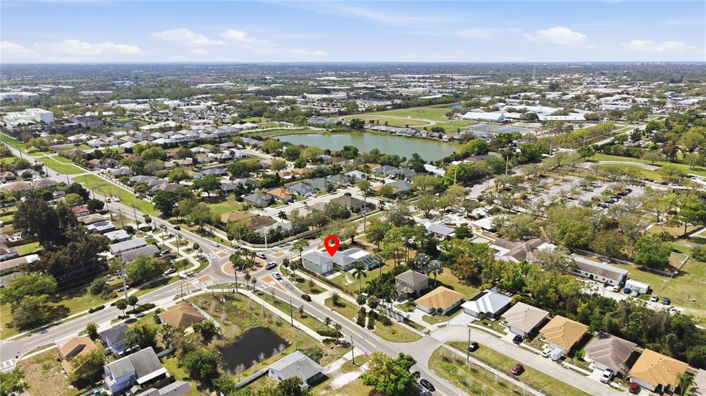 An aerial view shows a residential neighborhood with a red pin marking a specific house — 5251 ASHTON ROAD, SARASOTA, FL