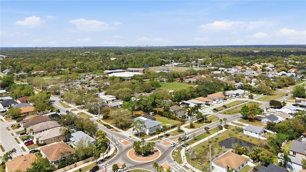An aerial view shows a suburban neighborhood with a roundabout and a nearby school — 5251 ASHTON ROAD, SARASOTA, FL