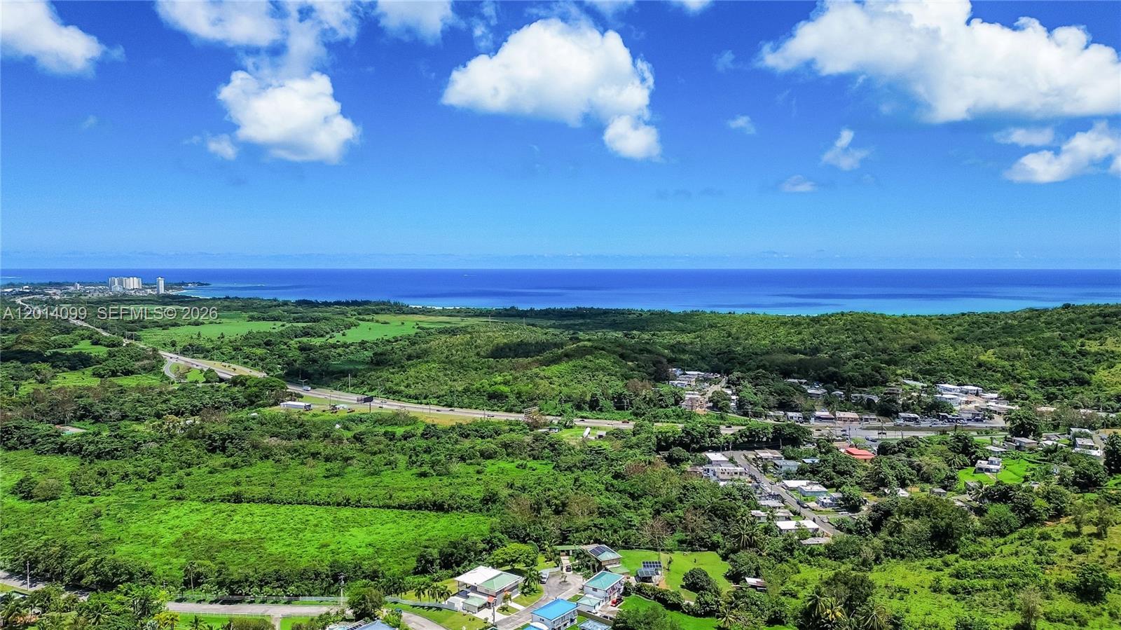 A swimming pool with a water feature sits below a stone-walled terrace and building — 95 N Melao, PR 00773, PR