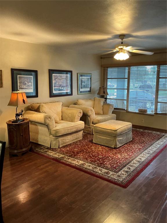 A living room features two beige armchairs, a matching ottoman, and a patterned area rug — 4300 58TH STREET N UNIT 1801, KENNETH CITY, FL