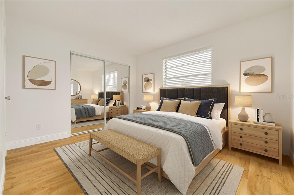 A bedroom features a bed with a dark headboard, a bench, and mirrored closet doors — 5715 S DALE MABRY HIGHWAY UNIT C, TAMPA, FL