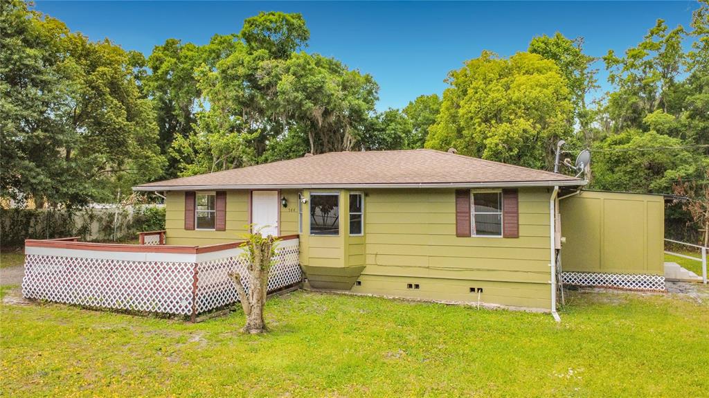 A one-story house with olive green siding, a front deck, and a bay window — 544 MERCURY AVENUE, ORLANDO, FL