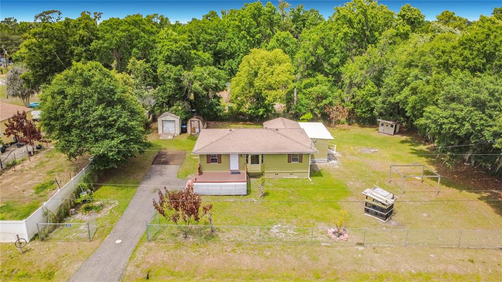 An aerial view of a green single-story house with a driveway and a fenced yard — 544 MERCURY AVENUE, ORLANDO, FL