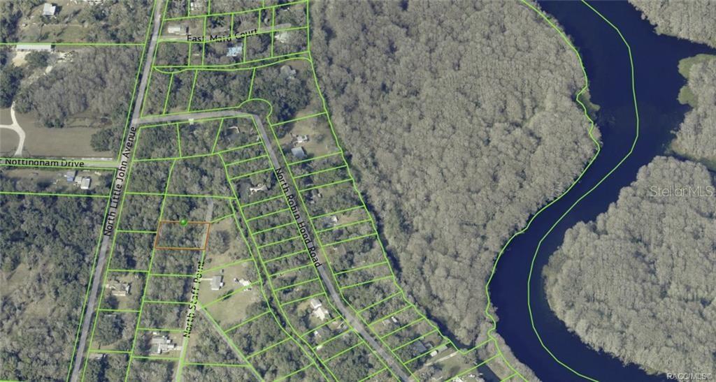 This is an aerial map showing a vacant lot outlined in orange within a residential neighborhood — 384 N STAFF POINT, INVERNESS, FL