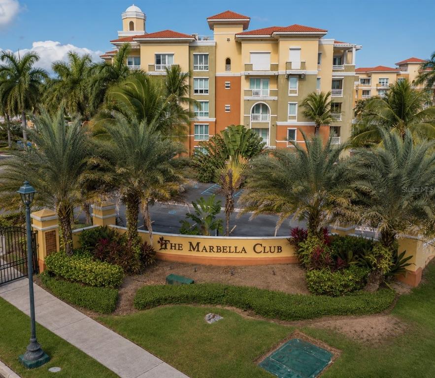 An exterior view of The Marbella Club apartment building with palm trees and landscaping — 200 OCEAN DRIVE UNIT 231, HUMACAO, PR
