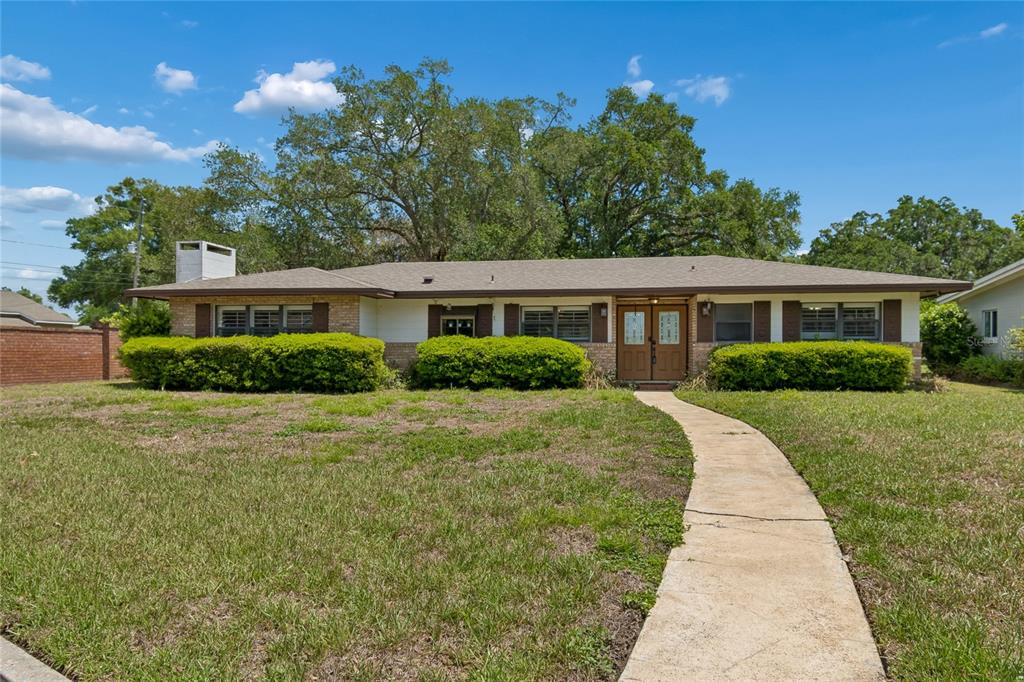 A concrete boat ramp leads into a lake with a wooden dock and park bench — 4801 BIG OAKS LANE, ORLANDO, FL