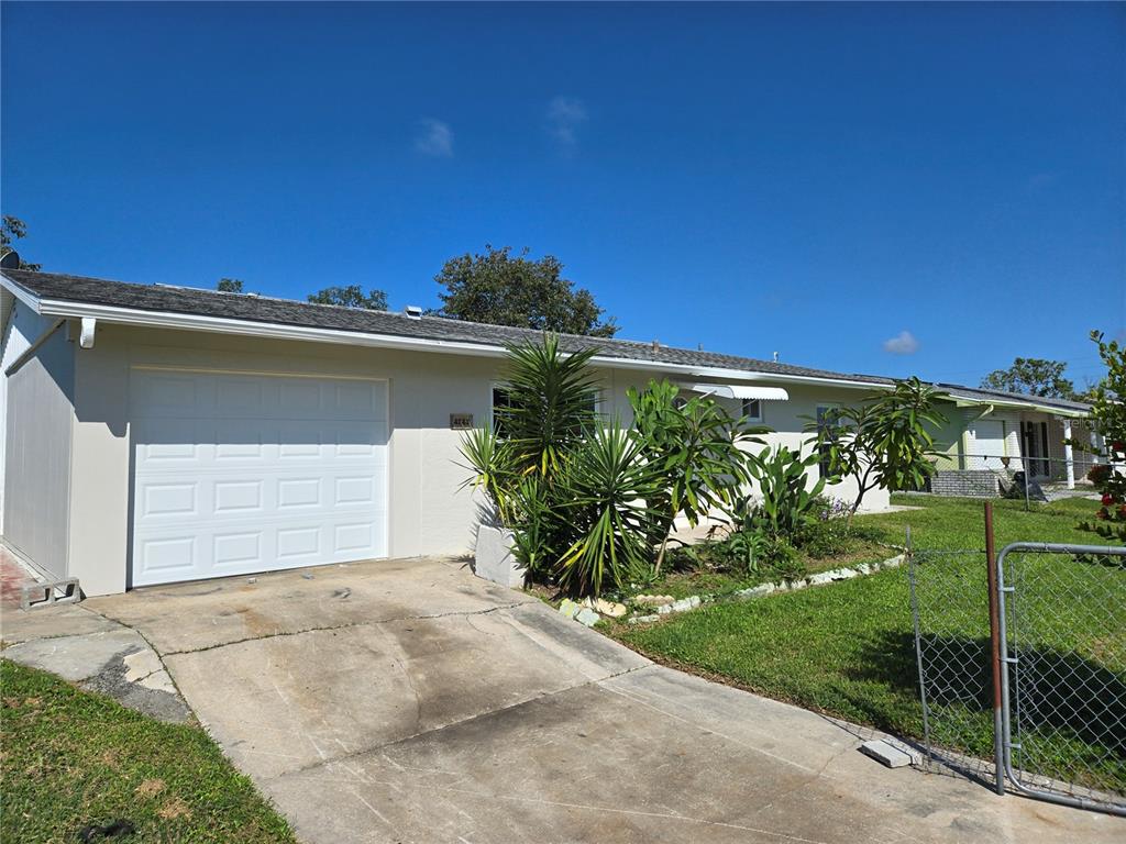 A single-story house with a white garage door, a concrete driveway, and front yard landscaping — 4149 GORGAS STREET, NORTH PORT, FL