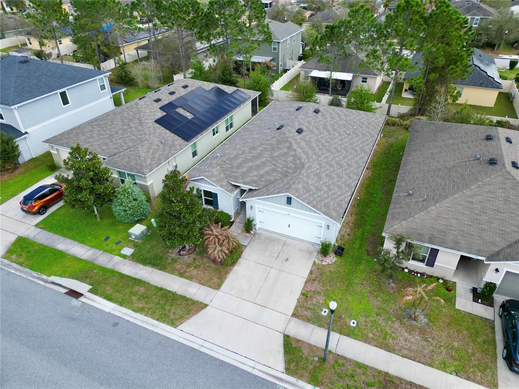 A single-story house with a white garage door, gray siding, and a concrete driveway — 1141 AUGUSTUS DRIVE, DAVENPORT, FL