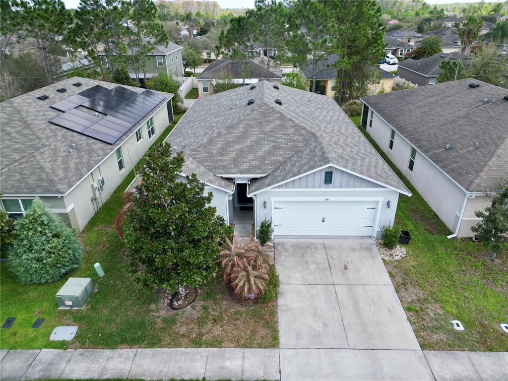 An aerial view of a single-story suburban house with a gray roof and driveway — 1141 AUGUSTUS DRIVE, DAVENPORT, FL