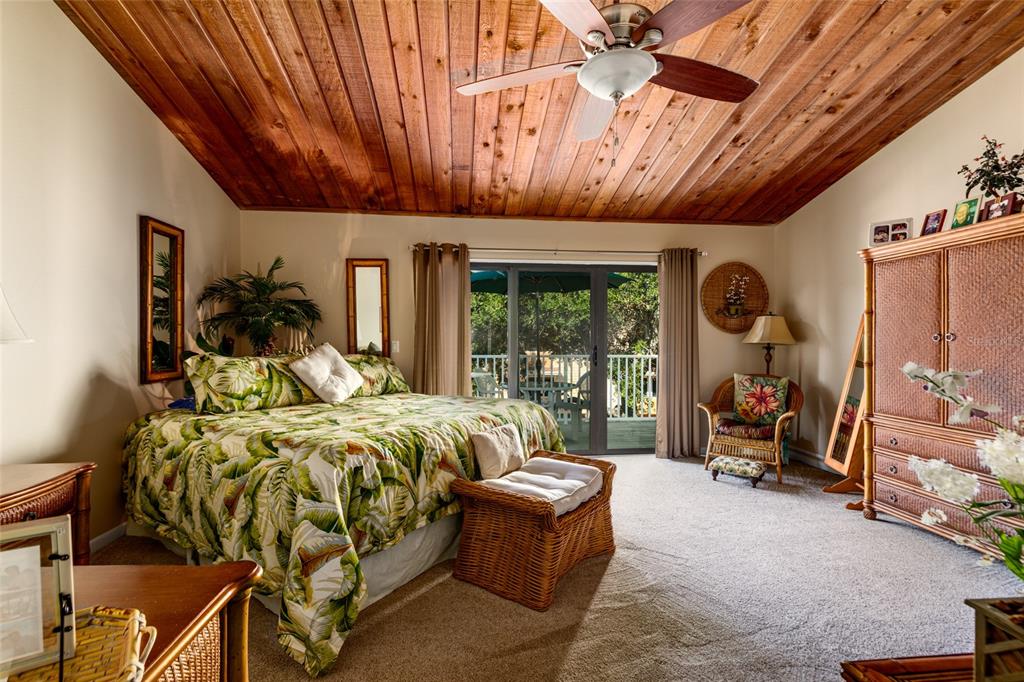 A garage with blue painted floors, storage shelving, a laundry unit, and a golf bag — 505 SANDY HOOK ROAD UNIT 505, TREASURE ISLAND, FL