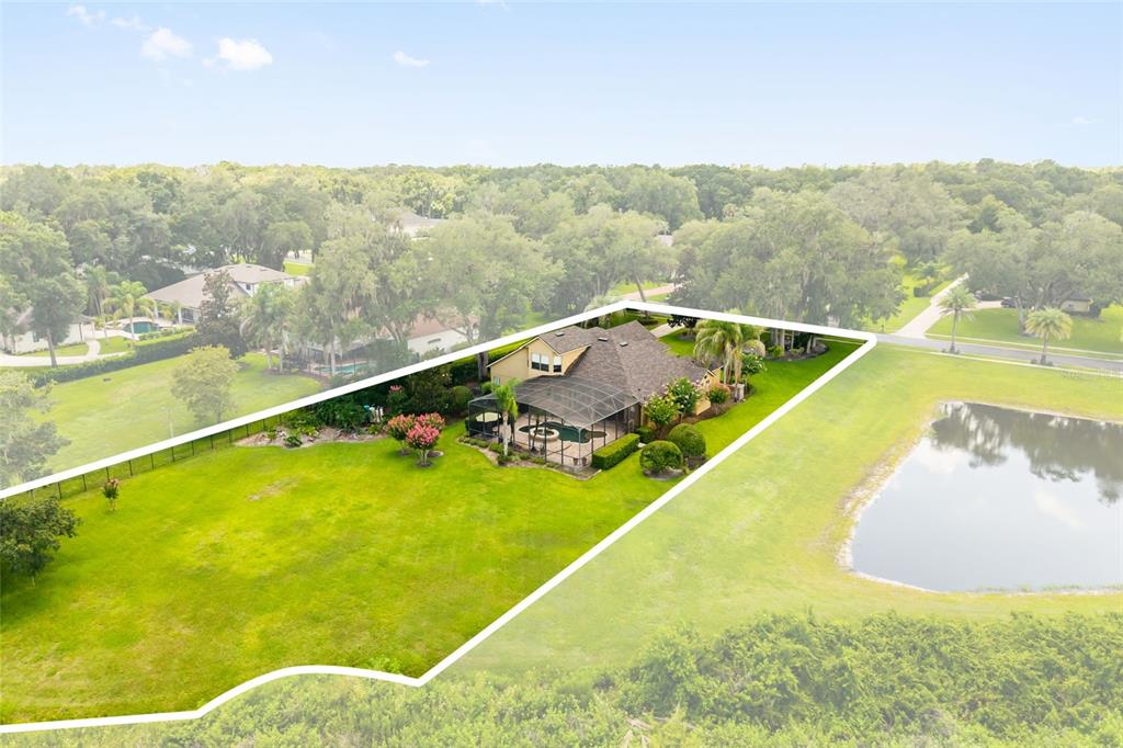 An aerial view shows a house with a pool enclosure situated on a large lot — 863 CARDINAL POINTE COVE, SANFORD, FL