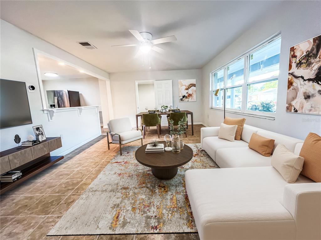 A living room and dining area feature tile floors, a sectional sofa, and a rug — 137 LOWELL ROAD, WINTER HAVEN, FL