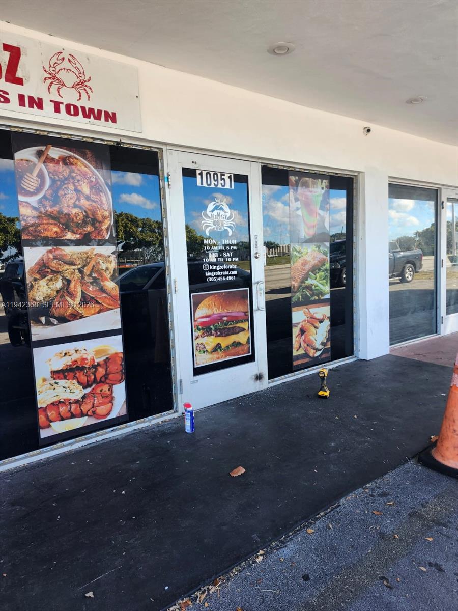 The exterior of a restaurant storefront features glass doors and windows with food advertisements — 10951 NW 27th Ave, Miami FL 33167, MIAMI, FL