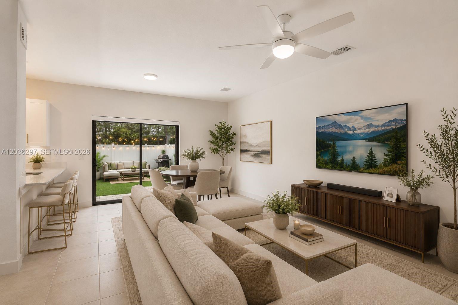 This living room features a sectional sofa, a media console, and a sliding door to a patio — 592 NW 203rd Ter, Miami Gardens FL 33169, MIAMI GARDENS, FL