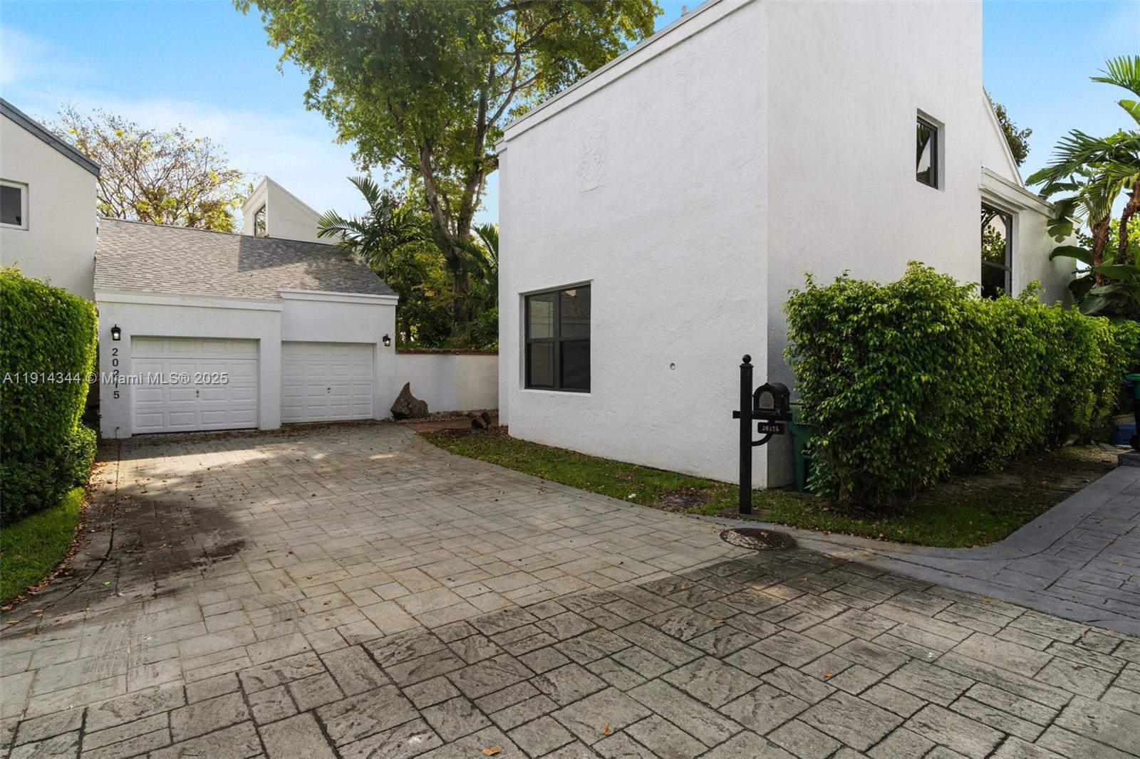 A white two-story house features a paved driveway, a two-car garage, and a mailbox — 20215 W Oak Haven Cir, Miami FL 33179, MIAMI, FL
