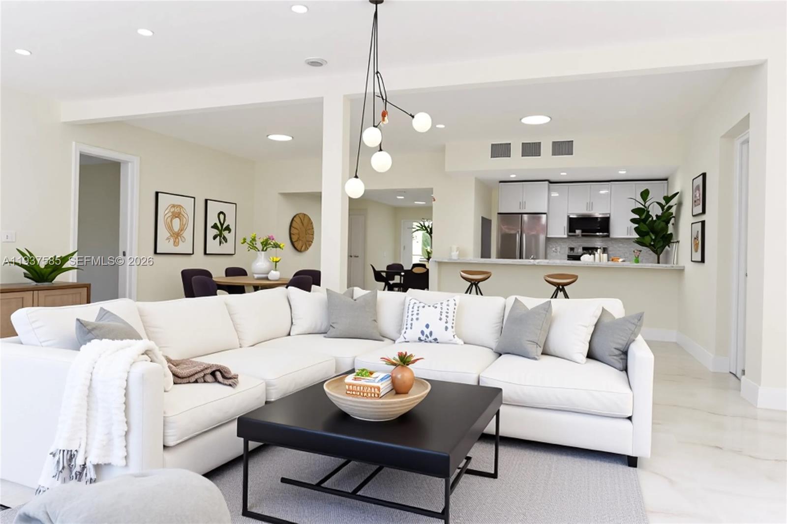 A white sectional sofa sits in a living room with a black coffee table — 4501 Jefferson St, Hollywood FL 33021, HOLLYWOOD, FL