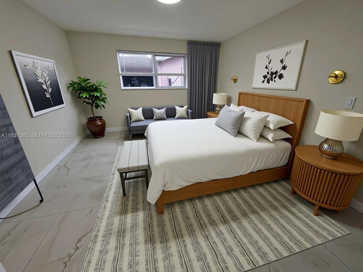 A bedroom features a wooden bed, a gray sofa, a patterned rug, and tiled floors — 4501 Jefferson St, Hollywood FL 33021, HOLLYWOOD, FL