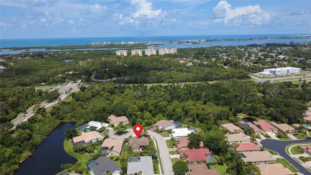 An aerial view shows a residential neighborhood with a red location pin on a house — 4092 HEARTHSTONE DRIVE, SARASOTA, FL