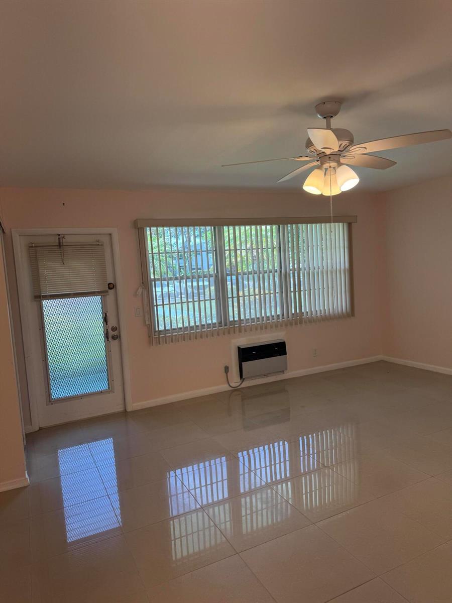 An empty room with light-colored tile floors, a ceiling fan, and a window with blinds — 463 Tilford V # 463, Deerfield Beach FL 33442, DEERFIELD BEACH, FL