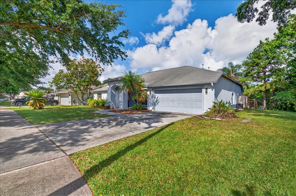 A single-story house with a gray garage, a concrete driveway, and a grassy front yard — 5068 ALAMANDA DRIVE, MELBOURNE, FL