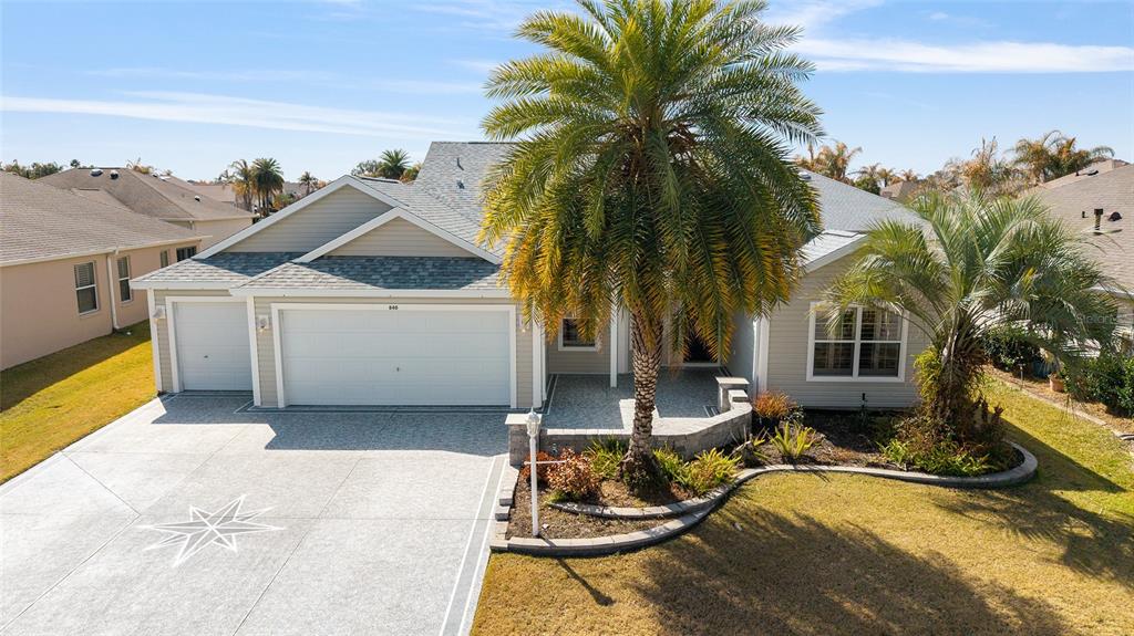 An aerial view of a single-story house with a three-car garage and palm trees — 840 FOLSUM PLACE, THE VILLAGES, FL