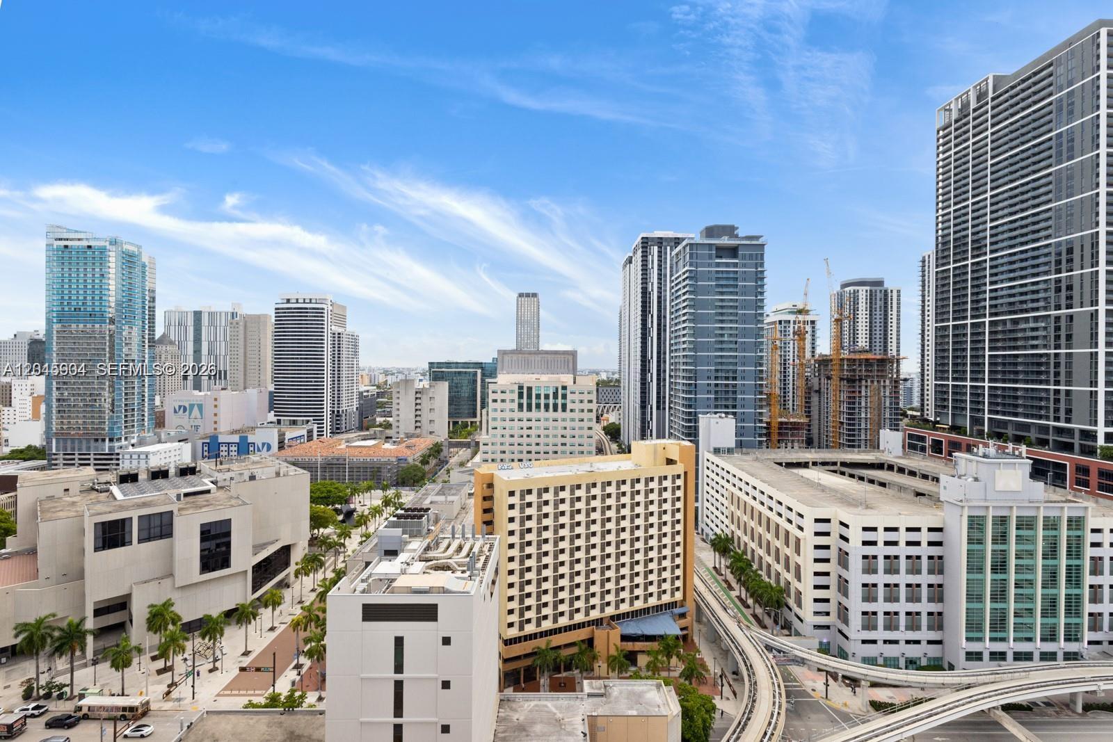 An elevated view of a dense urban cityscape featuring numerous high-rise buildings and a monorail track — 398 NE 5th St # 1518, Miami FL 33132, MIAMI, FL