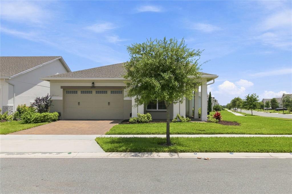 A single-story house with a two-car garage, a front lawn, and a paved driveway — 2699 MIDSWEET AVENUE, ST CLOUD, FL
