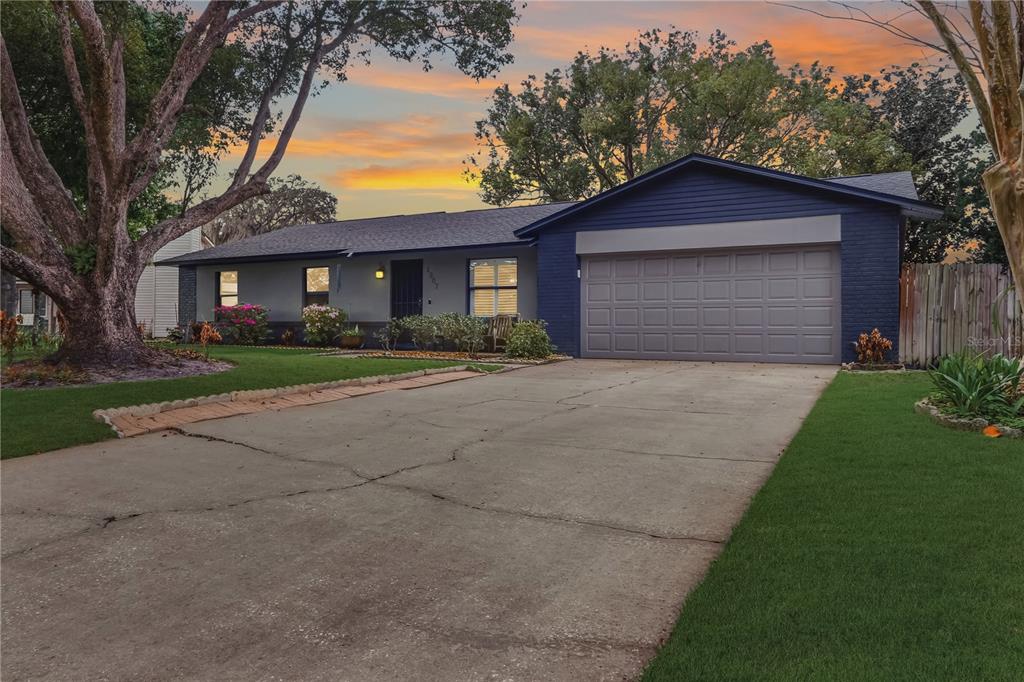 A single-story house with a blue brick exterior, a two-car garage, and a concrete driveway — 1307 ORTEGA STREET, WINTER SPRINGS, FL