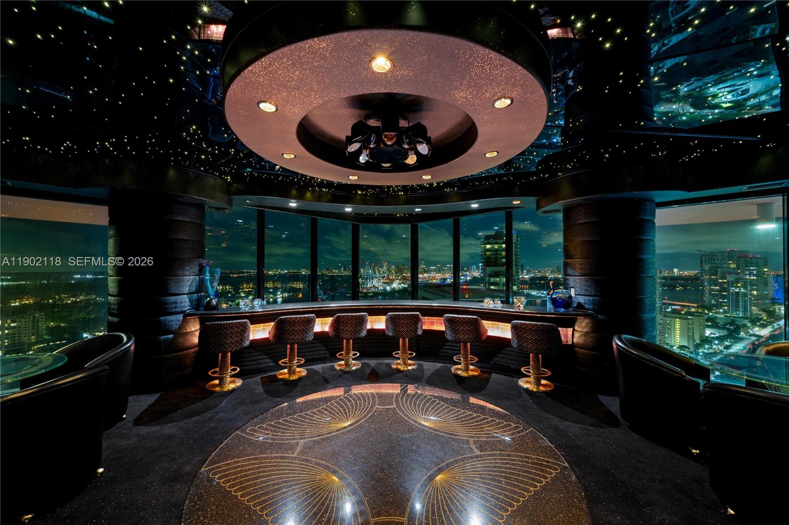 A circular bar area features a star-patterned ceiling, gold-accented stools, and panoramic city views — 300 S Pointe Dr # 3103, Miami Beach FL 33139, MIAMI BEACH, FL