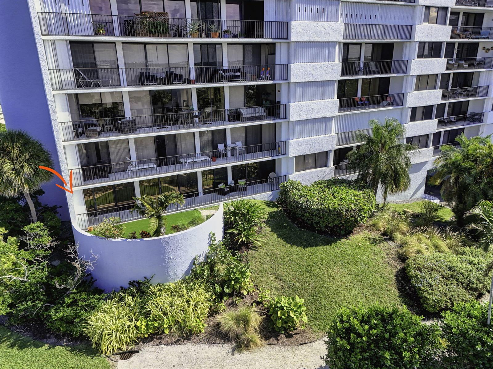 An elevated view of a multi-story apartment building with balconies and a curved patio area — 1300 Highway A1a Highway # 119, Jupiter FL 33477, JUPITER, FL