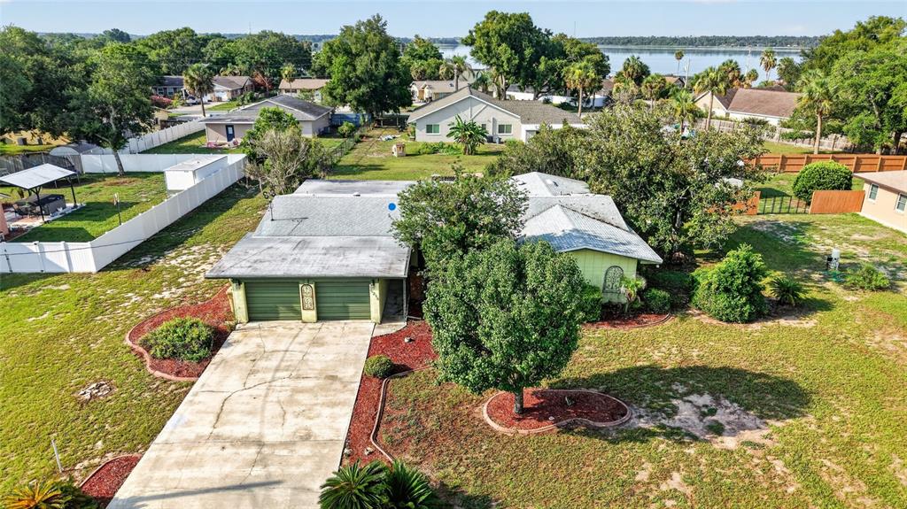An aerial view of a single-story house with a green garage and a large yard — 5216 SYDNEY ROAD, FRUITLAND PARK, FL
