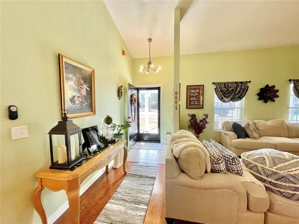 A view from a living room looking toward an entryway with a front door — 25336 SW 22ND AVENUE, NEWBERRY, FL
