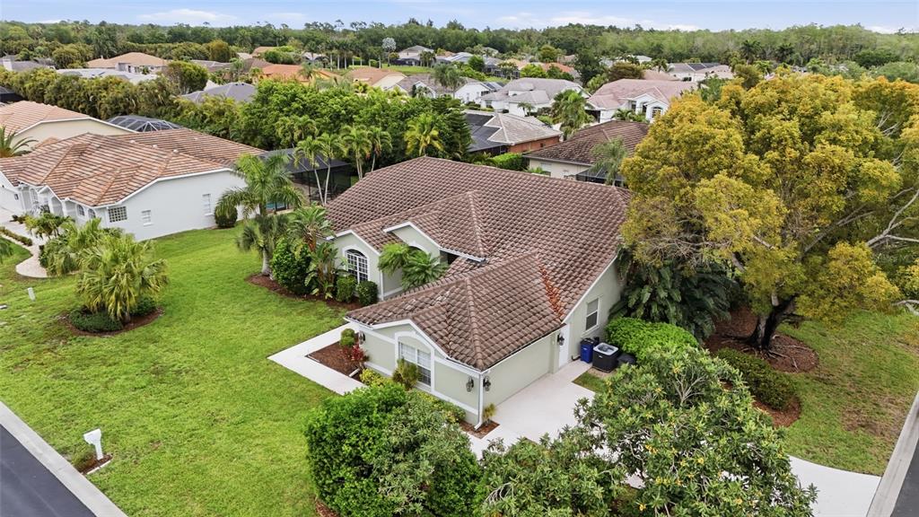 An aerial view of a single-story house with a tiled roof and green exterior walls — 12761 DRESDEN COURT, FORT MYERS, FL