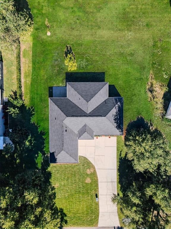 An aerial view shows a house with a dark shingled roof and a concrete driveway — 10711 LAKE HILL DRIVE, CLERMONT, FL