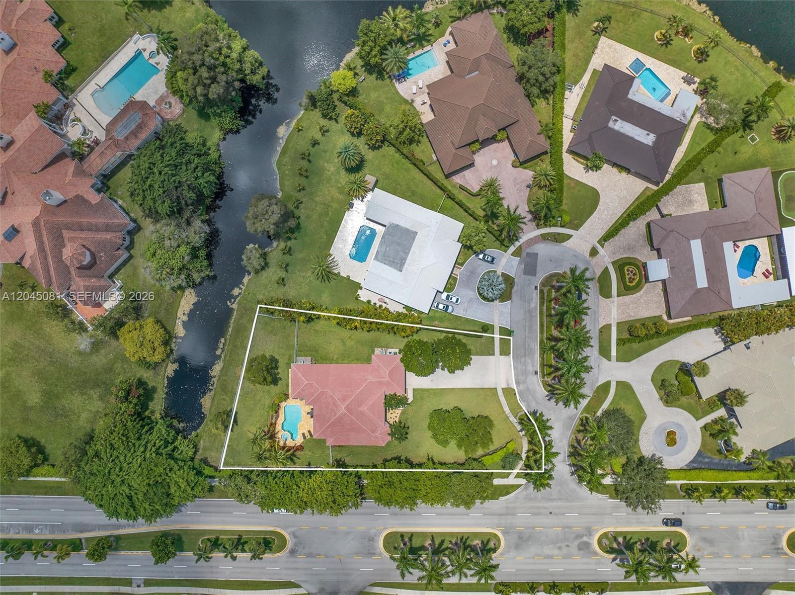 An aerial view shows a residential property with a red-roofed house, pool, and surrounding landscaping — 16310 Paddock Ln, Weston FL 33326, WESTON, FL