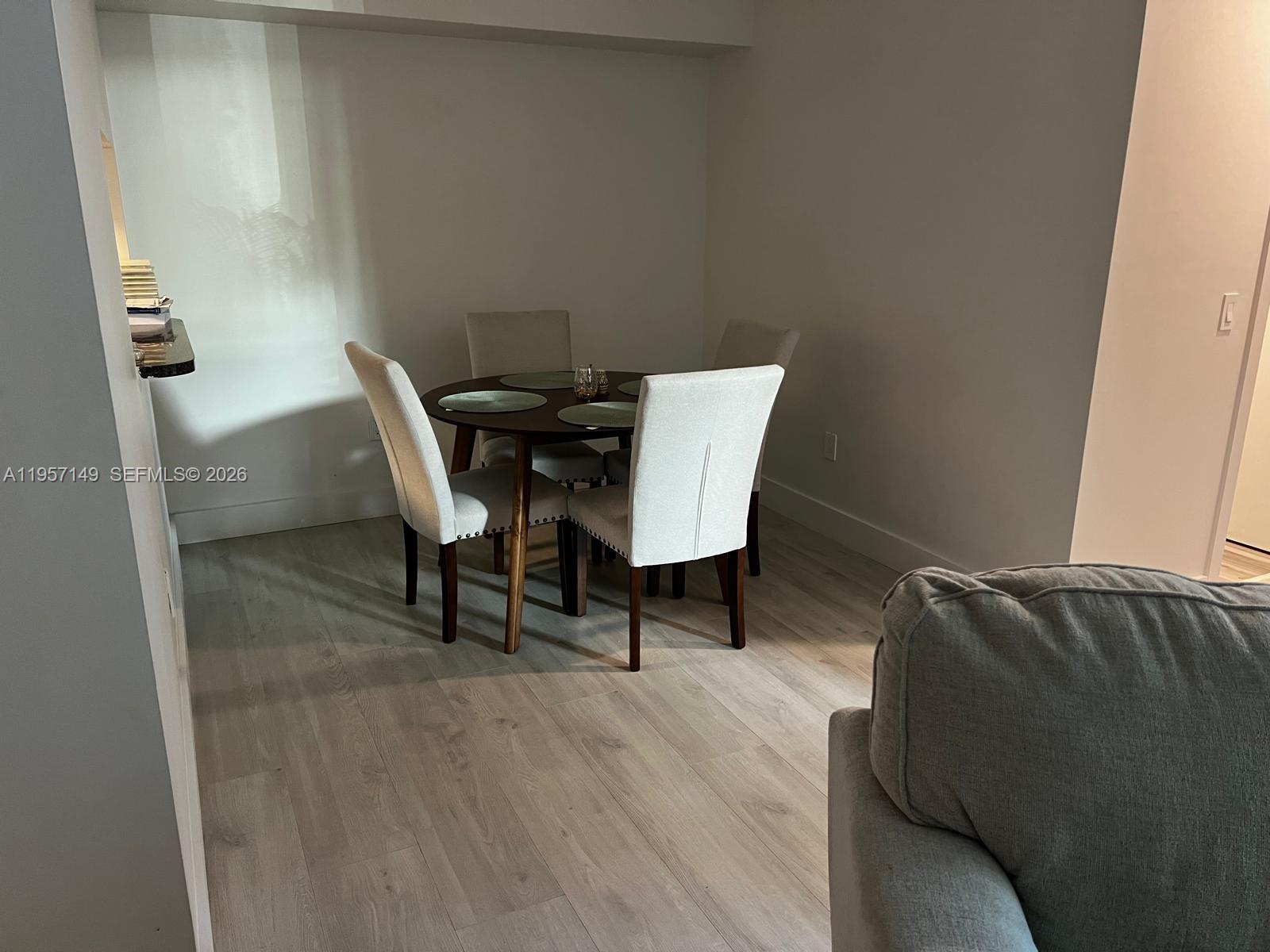 A dining area features a dark wood round table with four upholstered chairs on light flooring — 11750 SW 18th St # 1, Miami FL 33175, MIAMI, FL