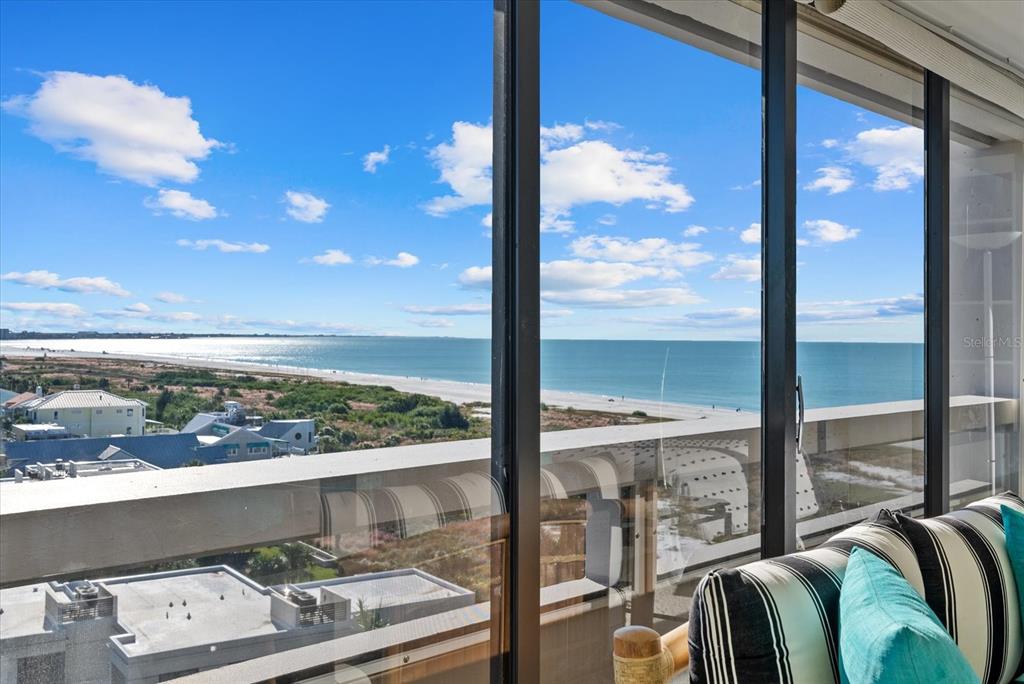 A view of the beach and ocean from a balcony with striped seating — 5400 OCEAN BOULEVARD UNIT 8-05, SARASOTA, FL