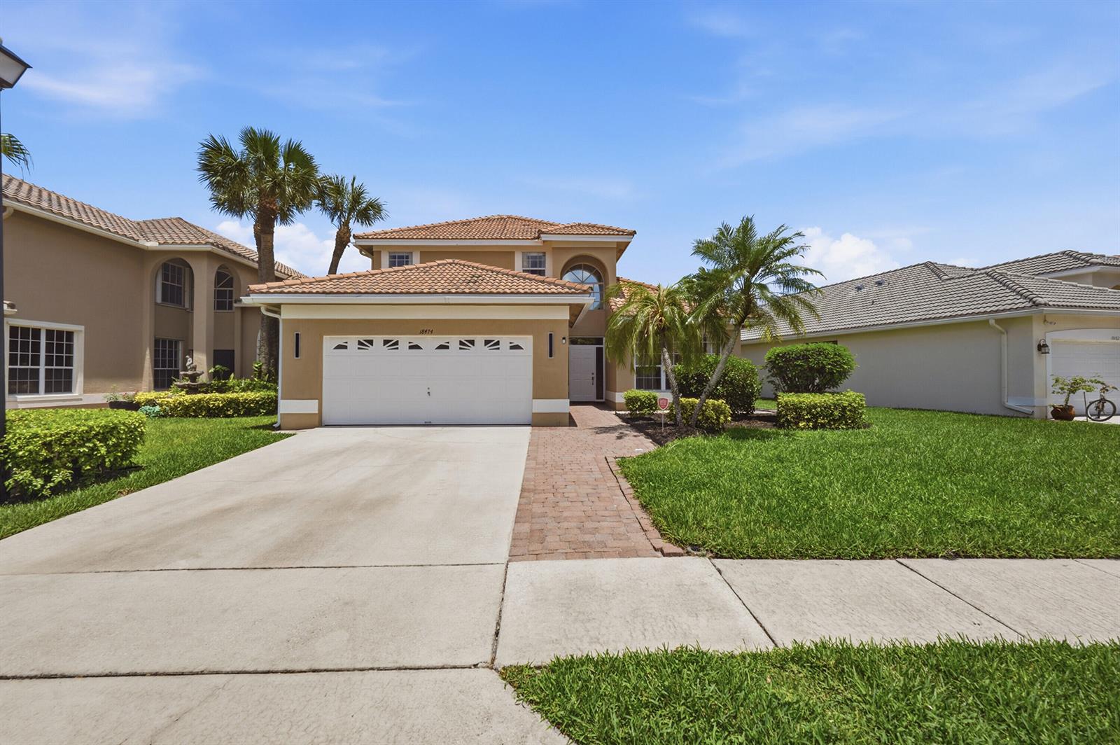 A two-story suburban house with a tile roof, a two-car garage, and a paved walkway — 18474 Old Princeton Lane, Boca Raton FL 33498, BOCA RATON, FL