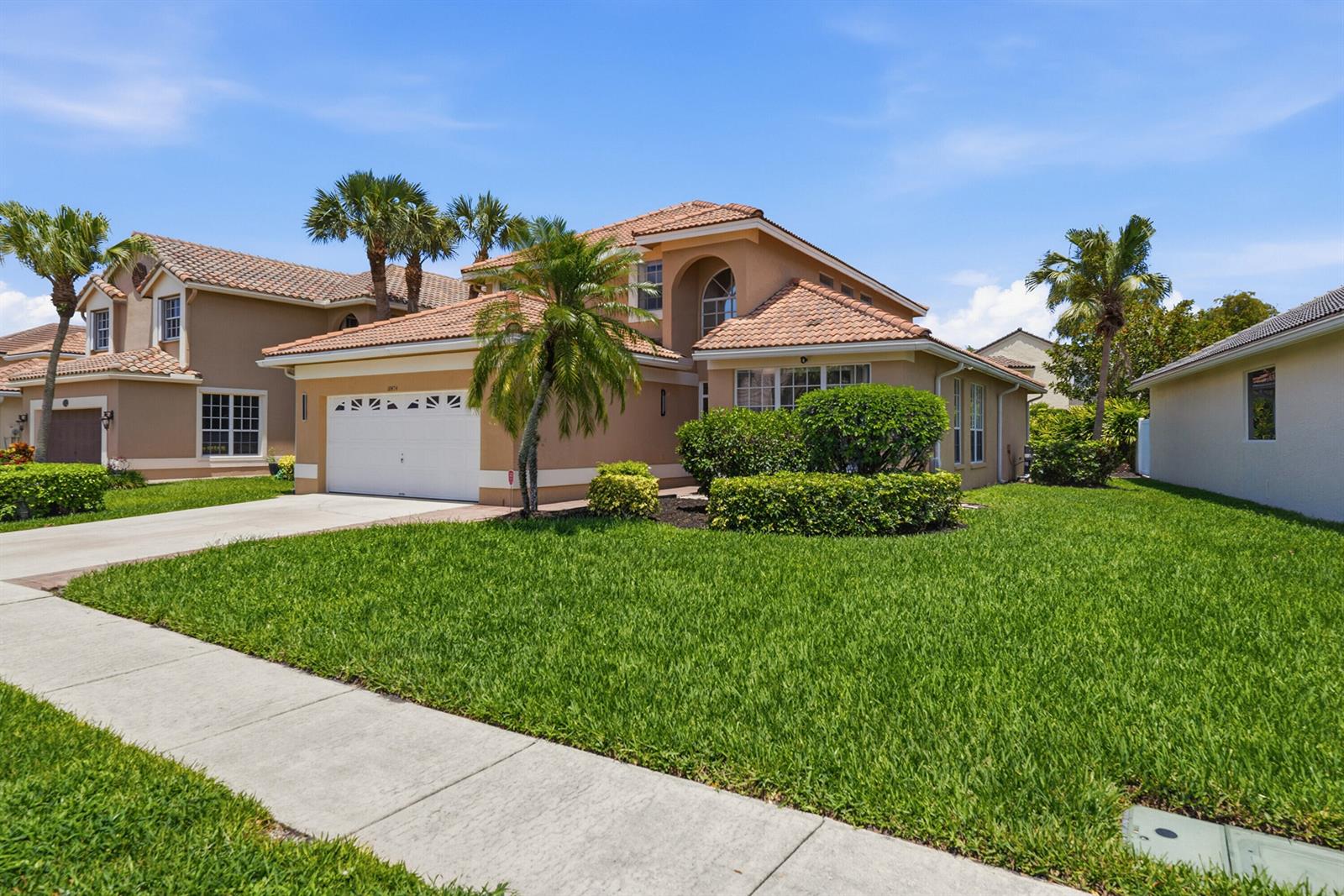 A two-story tan stucco house with a tile roof and a front-facing garage — 18474 Old Princeton Lane, Boca Raton FL 33498, BOCA RATON, FL