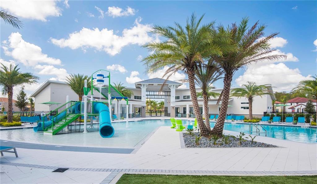 A swimming pool with a water slide and palm trees in front of a clubhouse — 2618 SANTOSH COVE, KISSIMMEE, FL