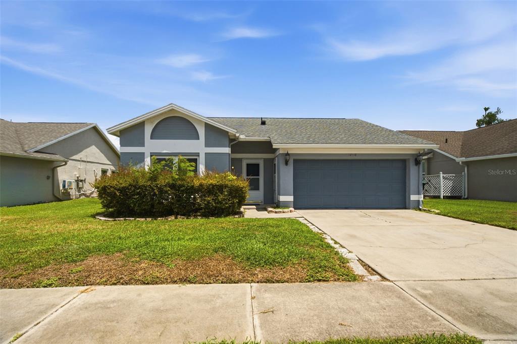 A single-story house with a gray exterior, a two-car garage, and a front lawn — 12118 DICKENSON LANE, ORLANDO, FL
