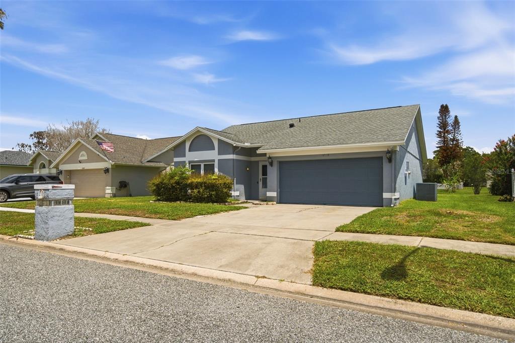 A single-story house with a gray exterior, a two-car garage, and a concrete driveway — 12118 DICKENSON LANE, ORLANDO, FL