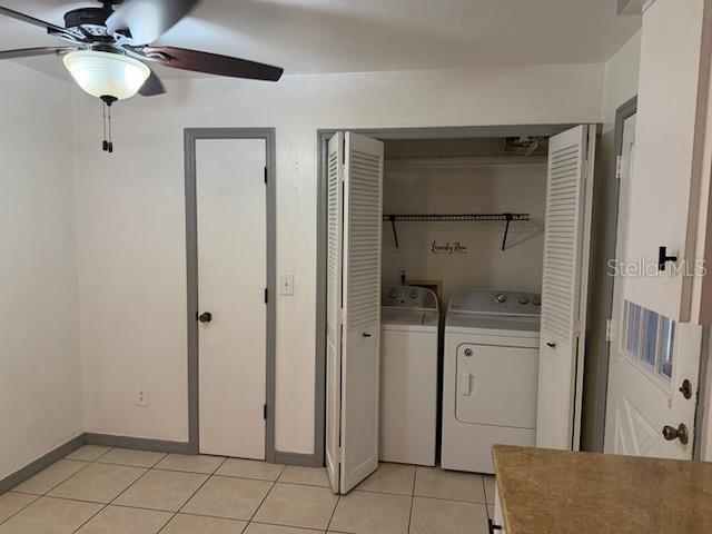 A room with white walls, tile flooring, a ceiling fan, and two closed doors — 2802 7TH STREET, ST CLOUD, FL