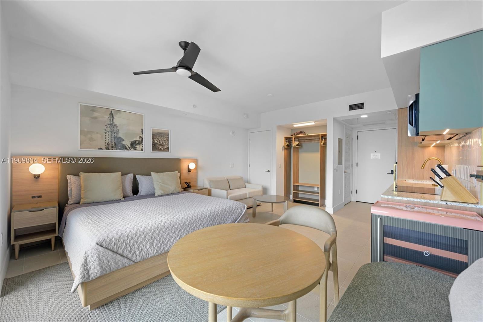 A studio apartment features a bed, a small dining table, and a kitchenette — 159 NE 6th St # 3706, Miami FL 33132, MIAMI, FL