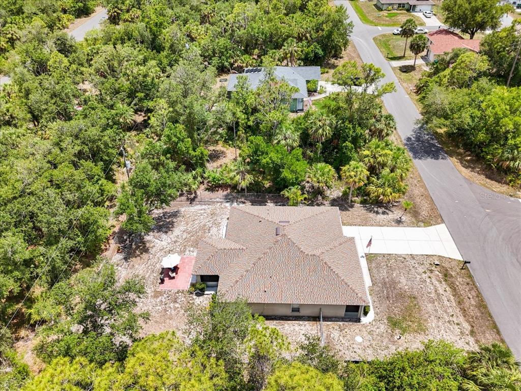 An aerial view shows a single-story house with a hip roof and a paved driveway — 3322 HAMPTON STREET, PORT CHARLOTTE, FL