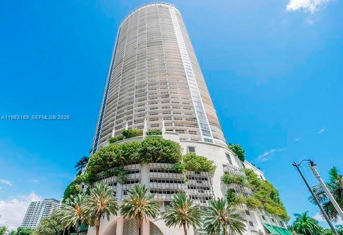 A low-angle view of a tall, cylindrical skyscraper with tiered, landscaped parking levels — 1750 N Bayshore Dr # 1104, Miami FL 33132, MIAMI, FL