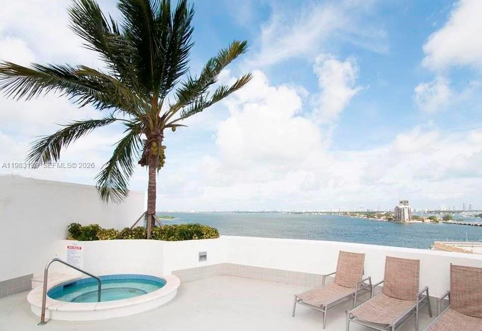 A rooftop terrace features a small circular hot tub, lounge chairs, and a palm tree — 1750 N Bayshore Dr # 1104, Miami FL 33132, MIAMI, FL