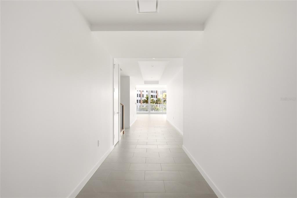An aerial view of a dense urban skyline featuring high-rise buildings near a large body of water — 400 CENTRAL AVENUE UNIT 407, ST PETERSBURG, FL