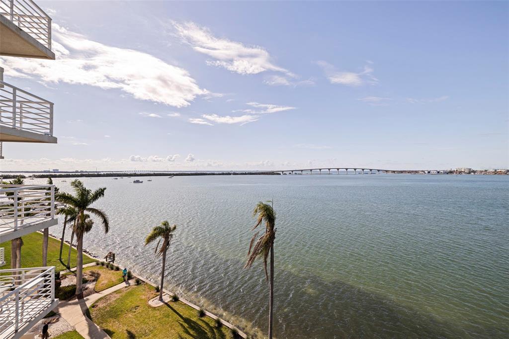 An elevated view of a waterfront balcony overlooking a bay with a bridge in the distance — 6105 BAHIA DEL MAR CIRCLE UNIT 683, ST PETERSBURG, FL