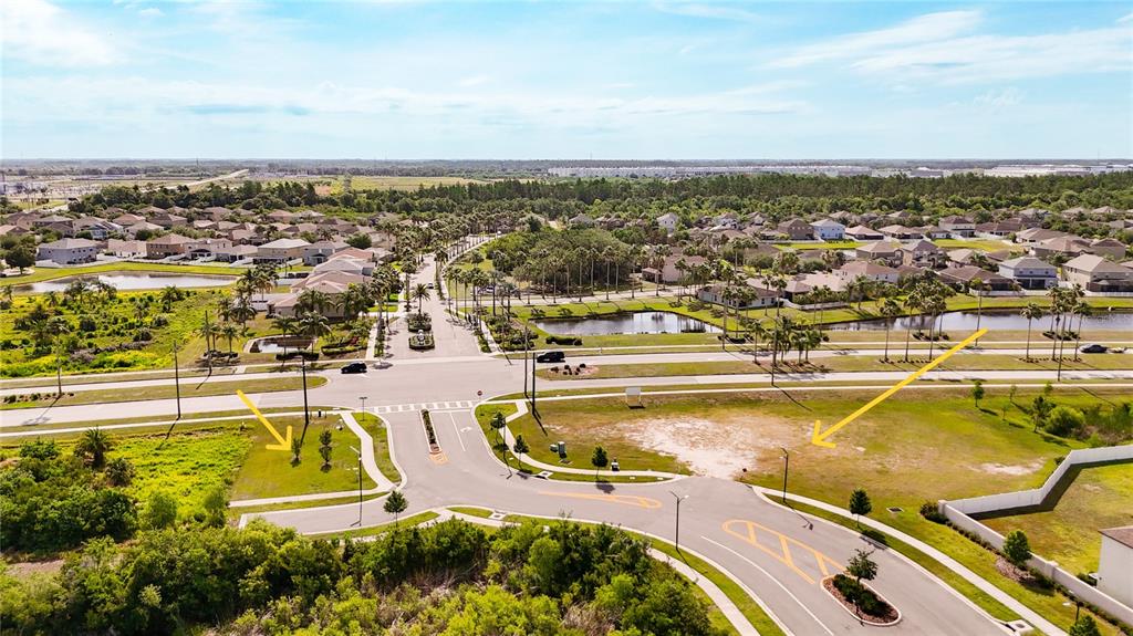 An aerial view shows a vacant residential lot at a suburban street intersection — 2282 JUNGLE DRIVE, RUSKIN, FL